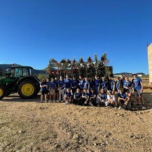 Students studying architecture from the University of Stuttgart posing infront of a tractor for a group photo in the middle of a spanish steppe landscape.