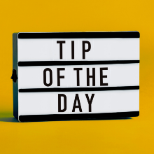 A luminous display with the words "Tip of the Day" in capital letters.