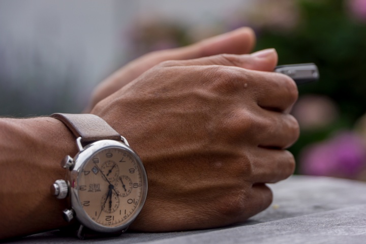 Symbol image of hand with wristwatch.