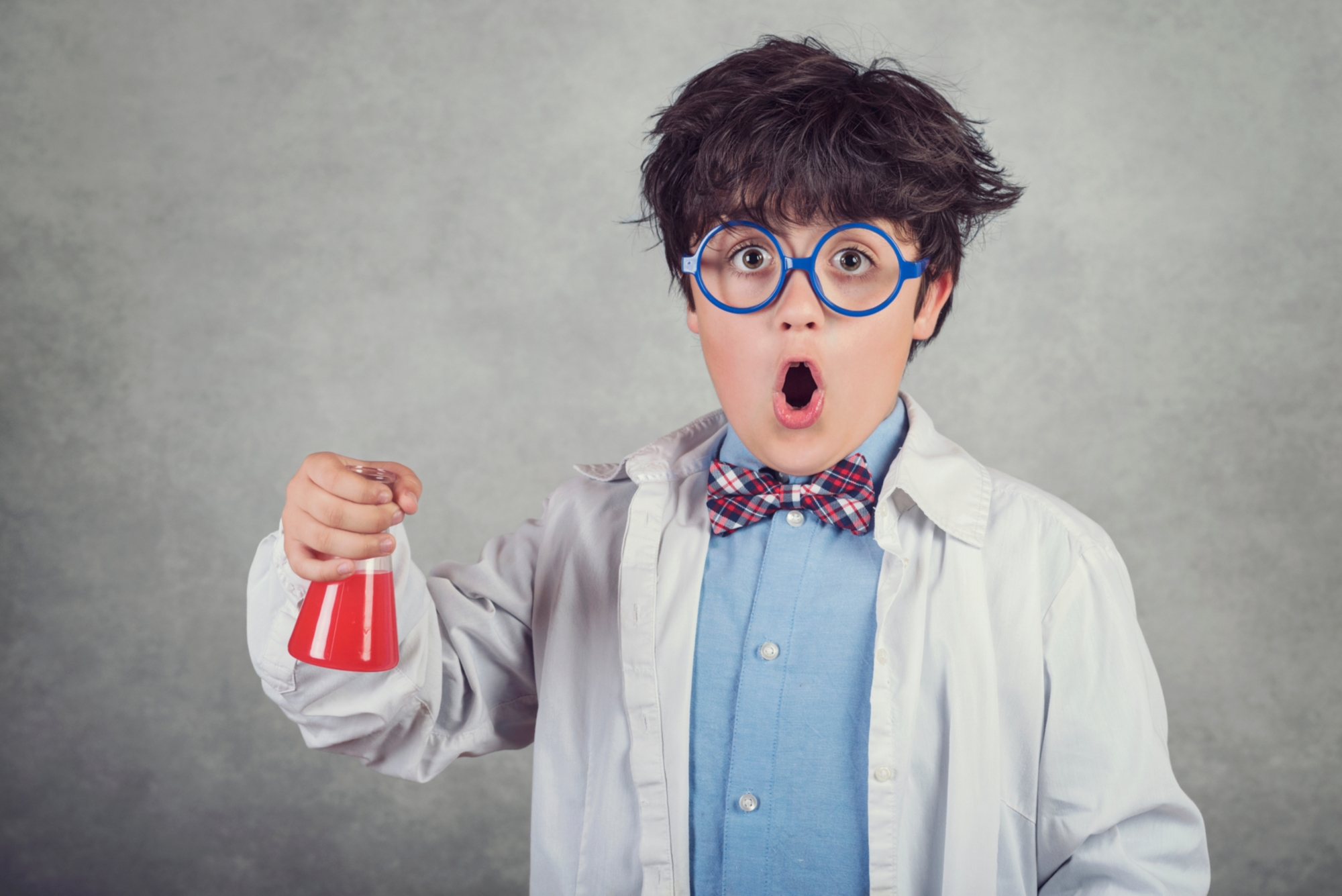 Symbol image of a child dressed as a scientist.
